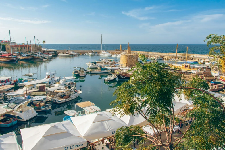 a sea port with many ships and parked cars