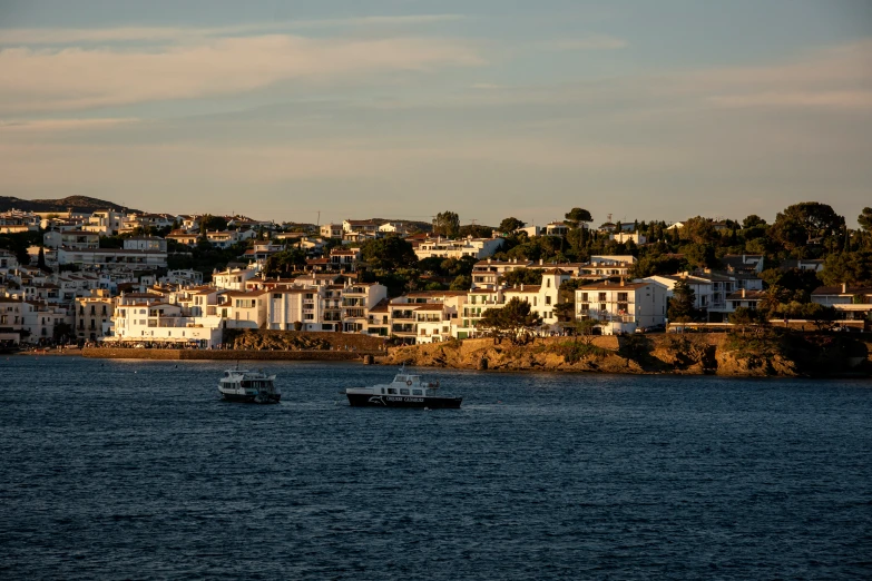 the three small boats are anchored in the blue water