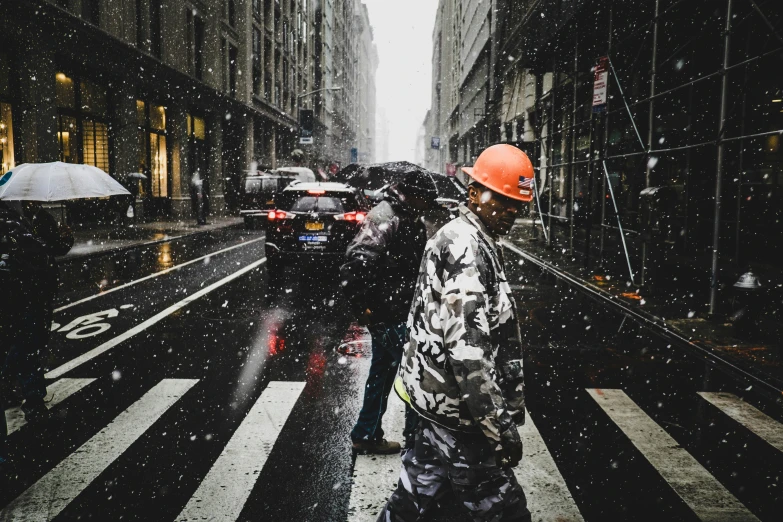 a group of people walking across a street