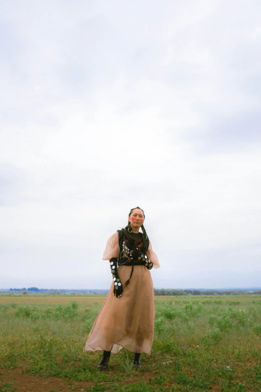 a woman is in a dress and holding a frisbee