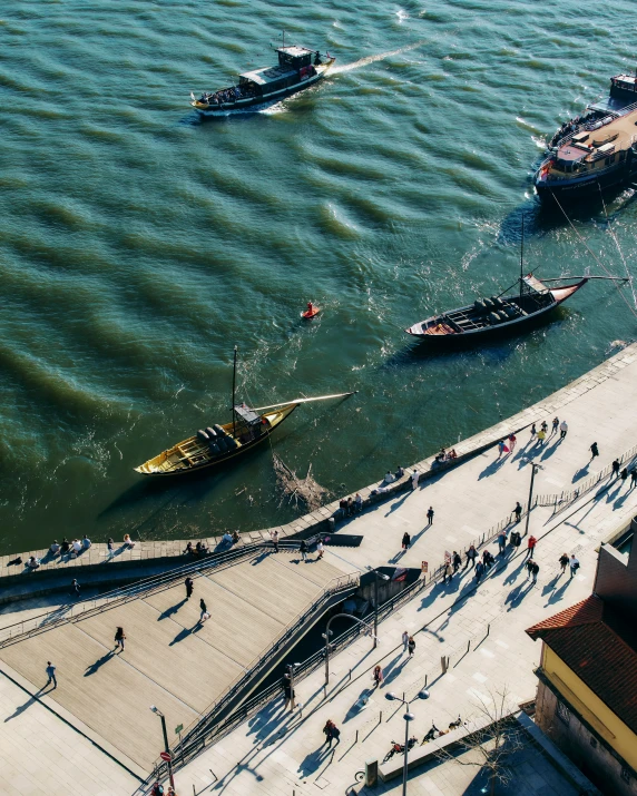 boats on a river with the ocean nearby