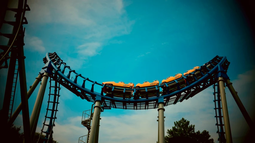 a roller coaster with several yellow chairs on top of it