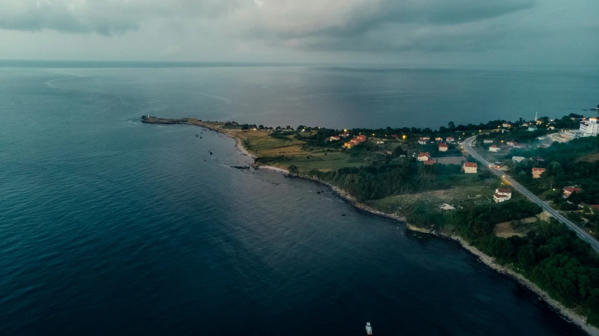 an island in the middle of the ocean with houses on it