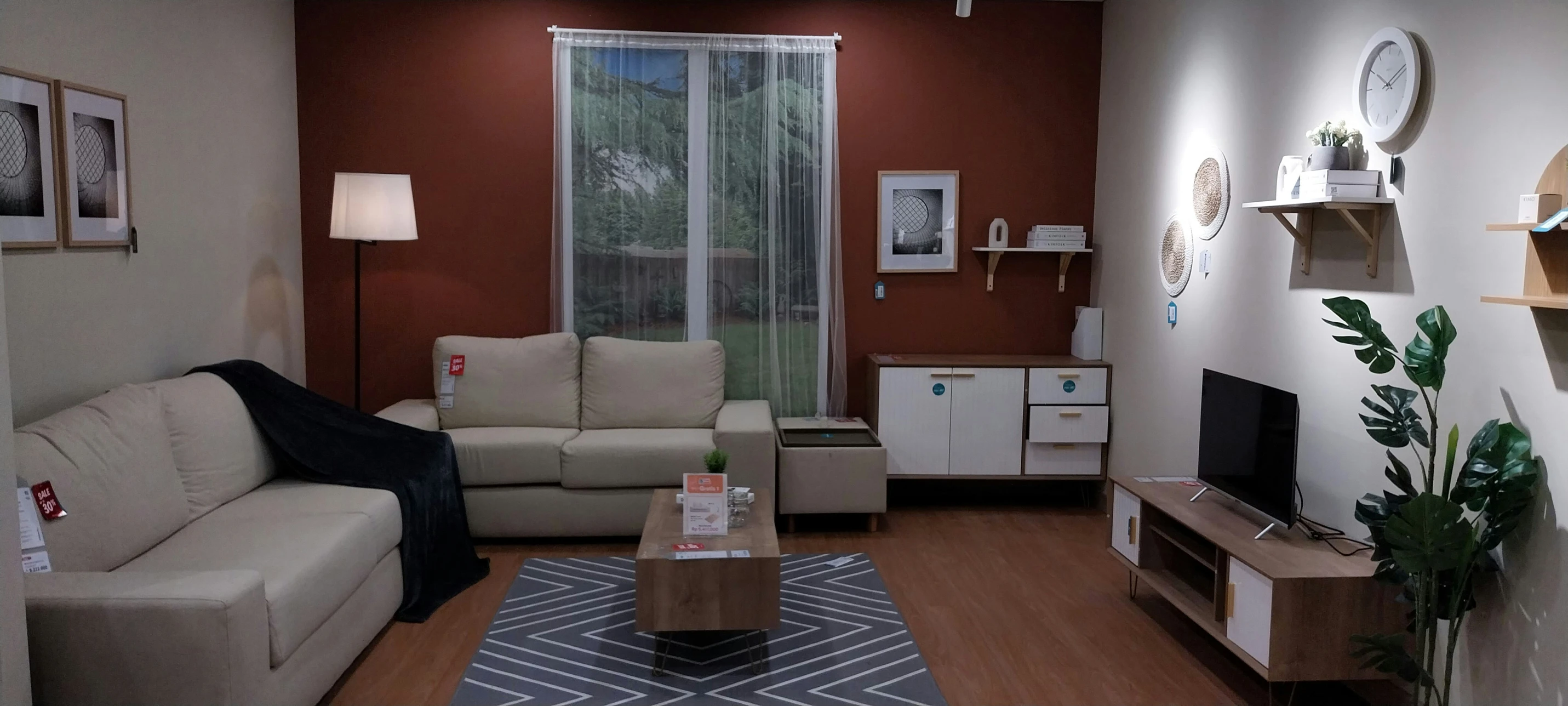 a living room with brown walls and white furniture