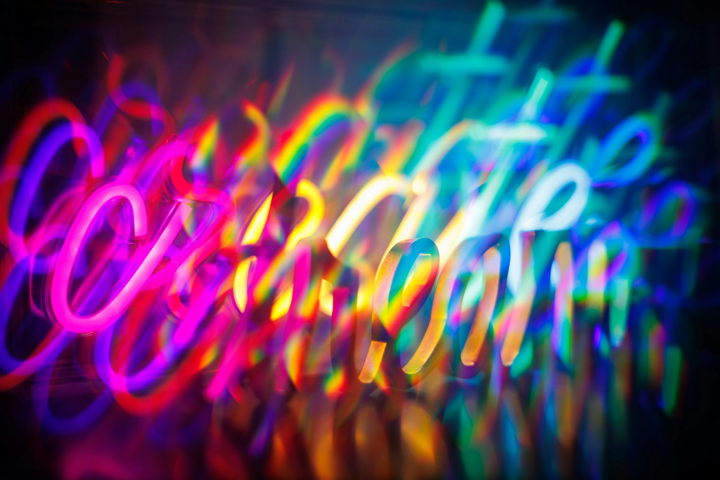 multicolored neon - light pograph of the text god created with a circular object