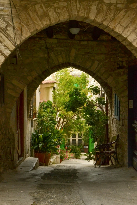 a doorway into a courtyard leading to an outside seating area