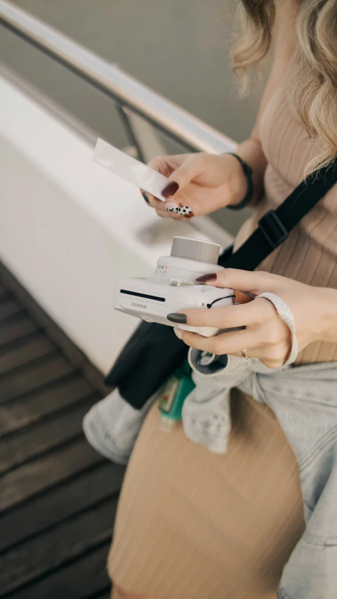 a person standing holding some papers in their hands