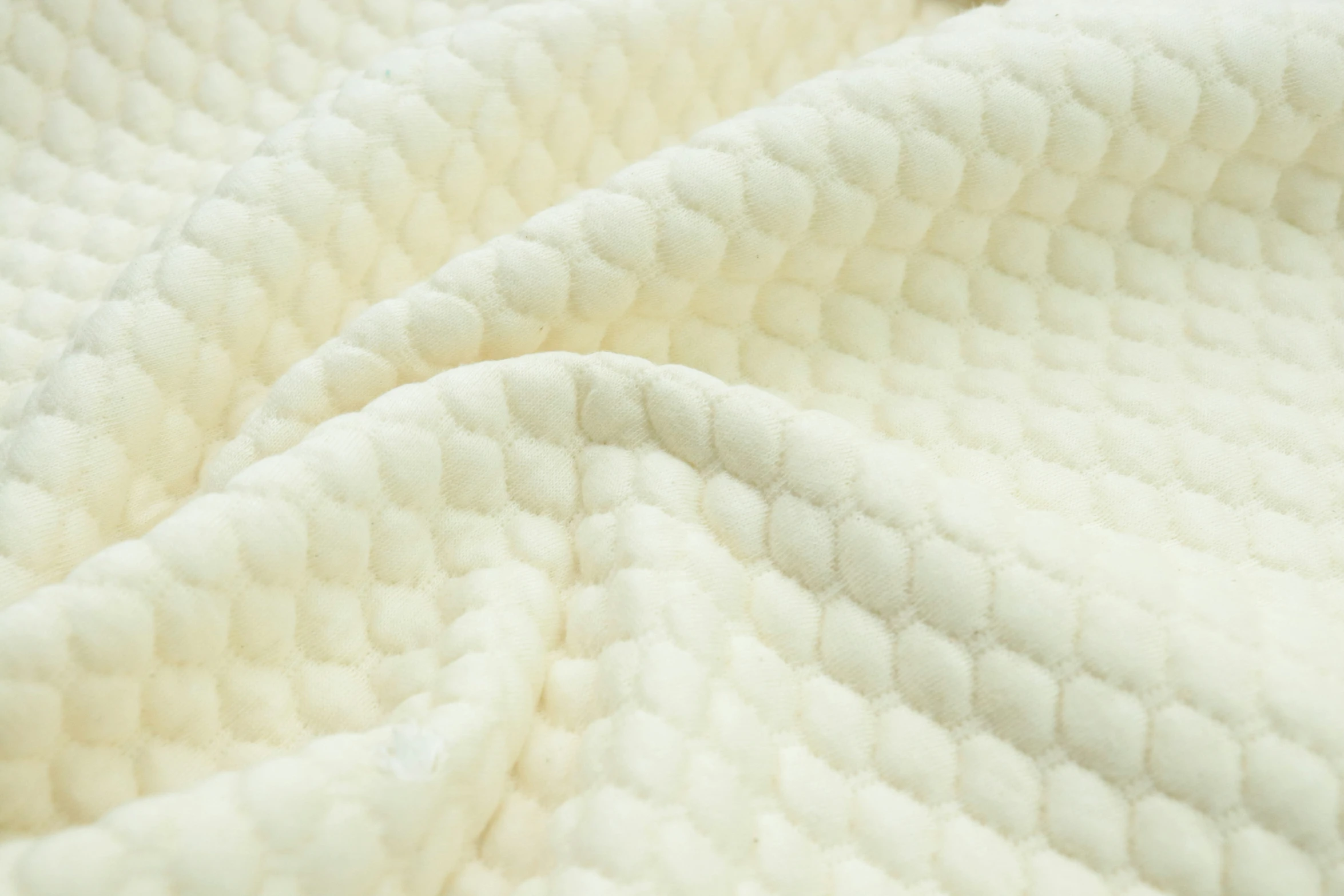 a white quilt that is covering soing on the surface