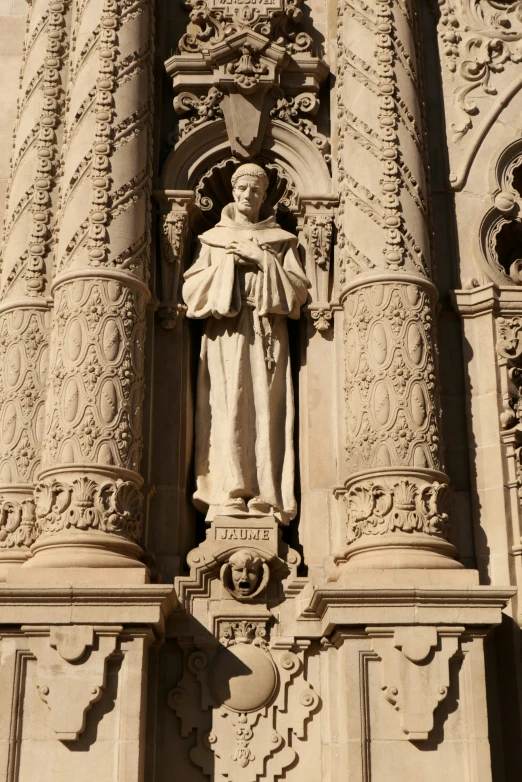 statue of saint joseph above stone arch on building
