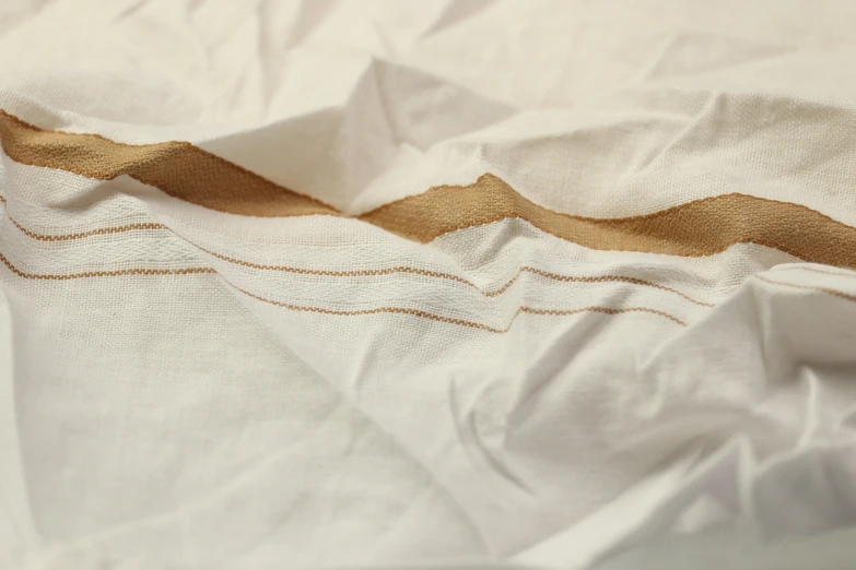 an up close picture of white linen with brown lines