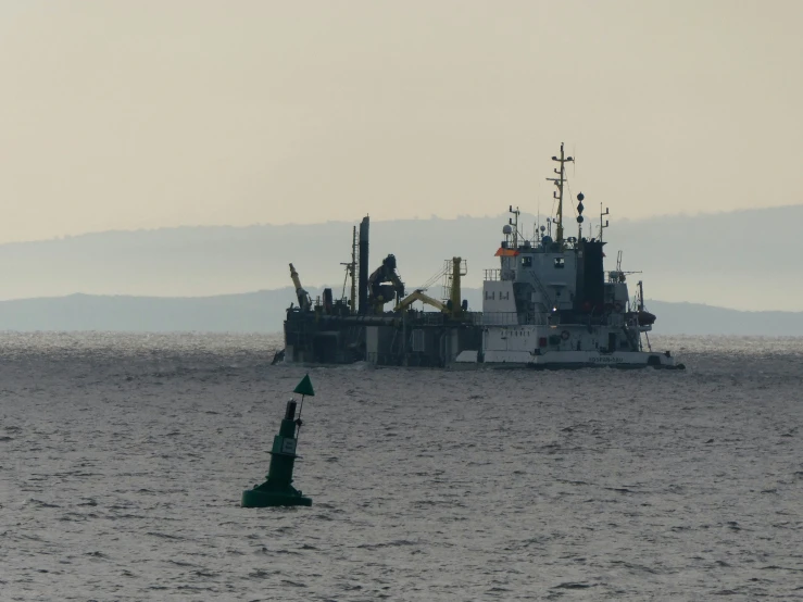 a ship and a buoy in the ocean