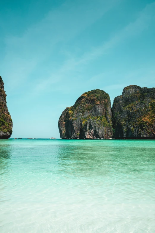 two big rocks are in the blue waters