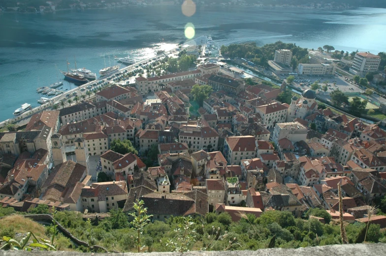 the cityscape has several large bricked houses on the hillside