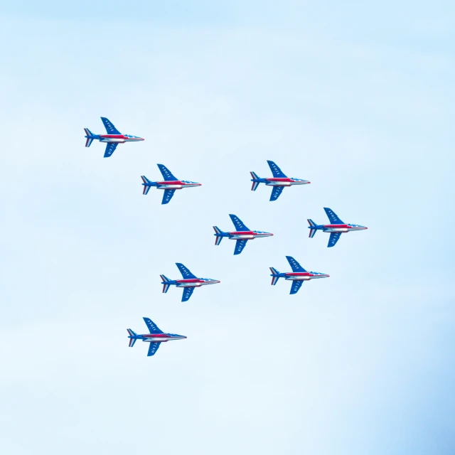 a formation of jet airplanes flying in the air