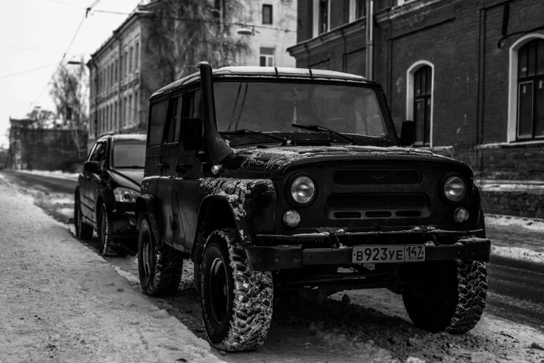 an old and dirty jeep parked next to a old road