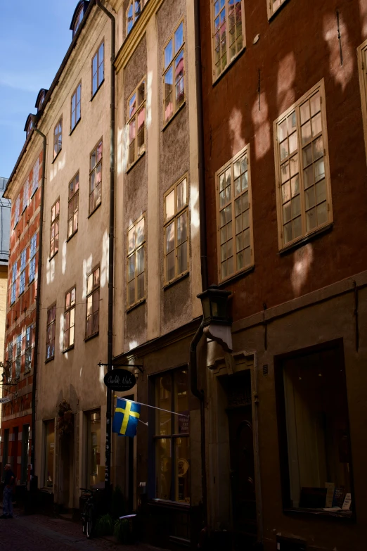 several windows shine brightly on the bricked buildings