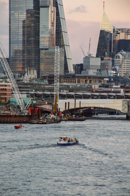 a boat in a body of water next to some very tall buildings