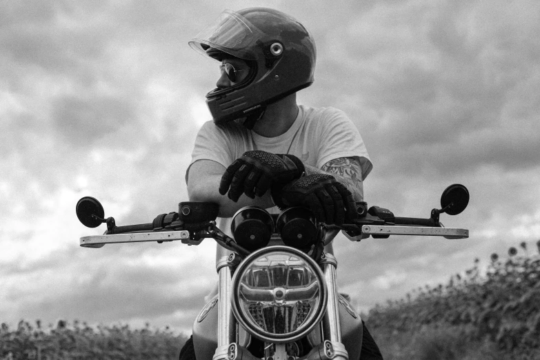 man wearing motorcycle helmet and gloves on motorcycle