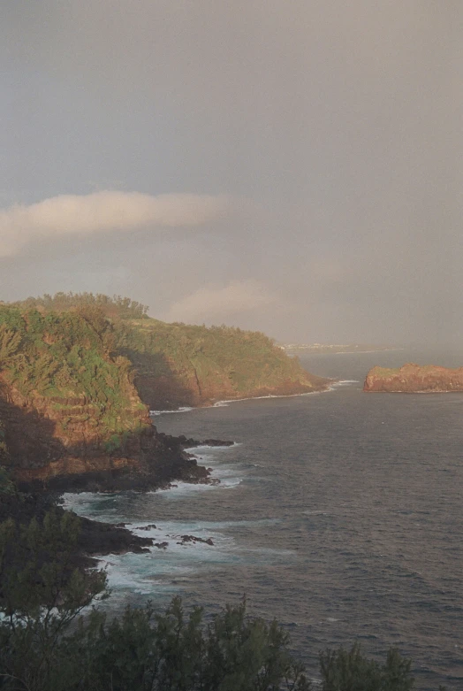 the ocean has many waves and brown hills