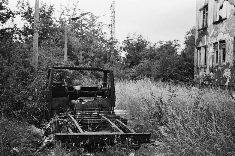 an old farm machinery tractor sitting in a field