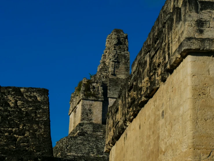 some stone buildings in front of a blue sky