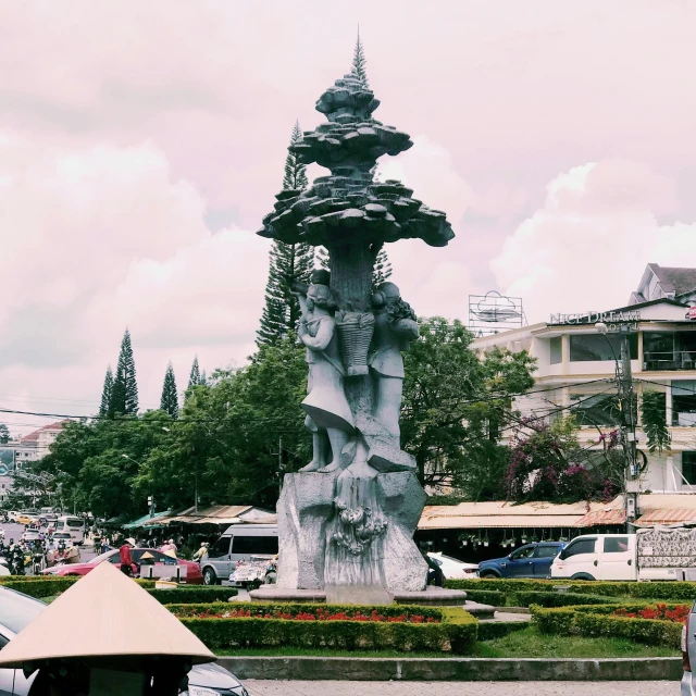 some large statues sit near each other in the middle of a park