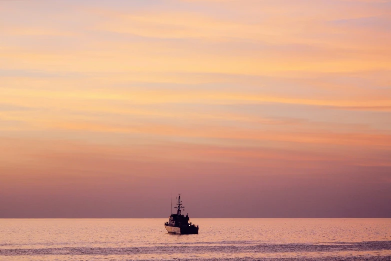 a boat on the sea during a sunset or sunrise