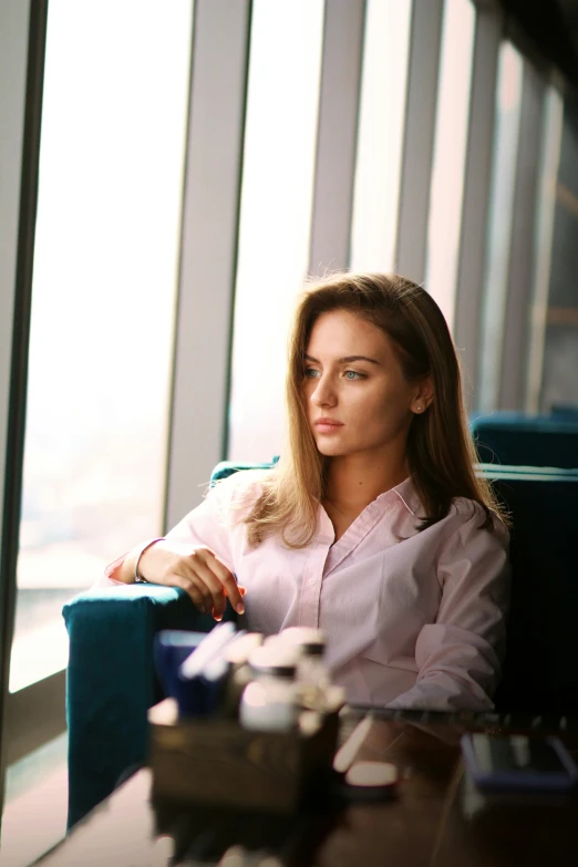 a woman is sitting in the corner of a room