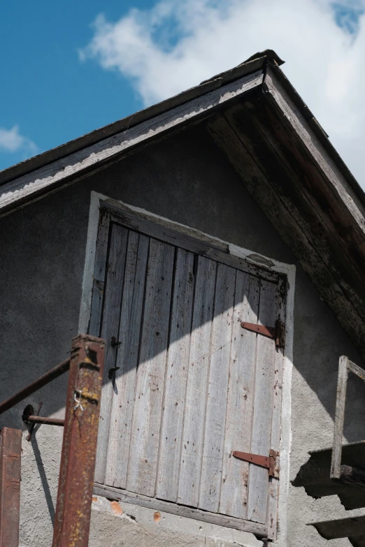 a worn out barn door is next to some stairs