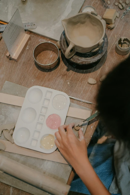 a woman working with dough on a table