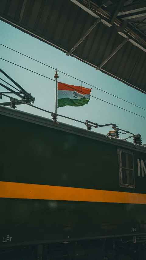 the indian flag is hanging from a train