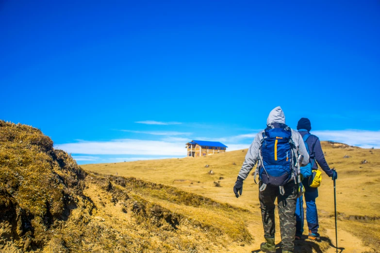 two people are hiking up the mountain together