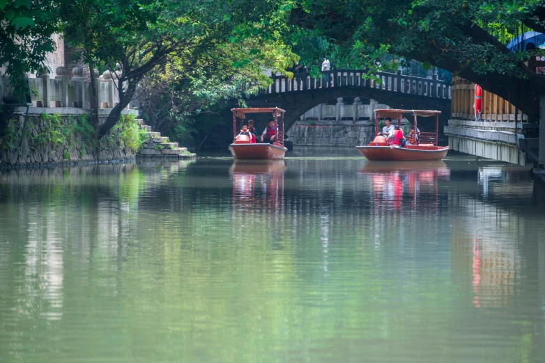 a group of people riding in small boats