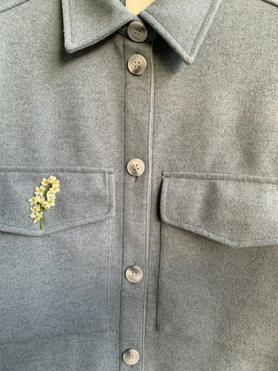 a shirt that has a boutonette pinned on the lapel