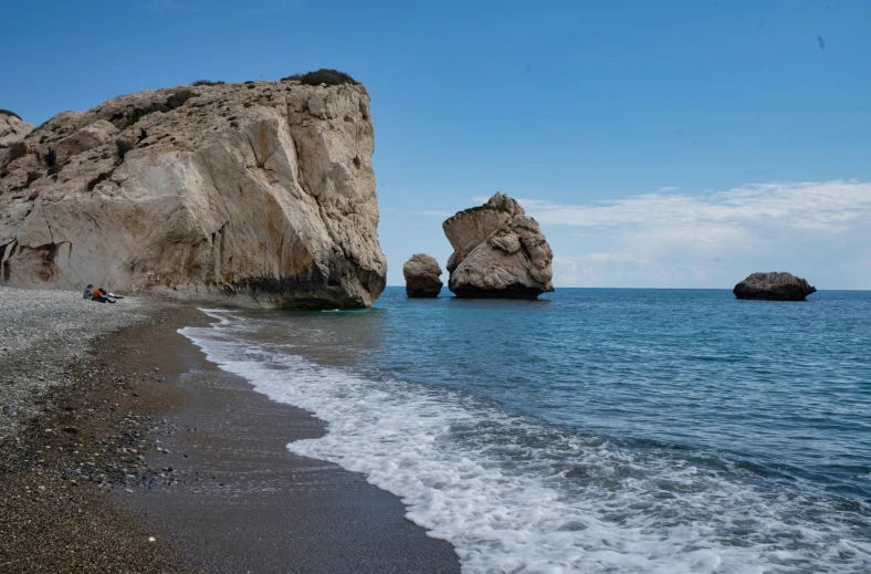 two large rock formations are visible from the water