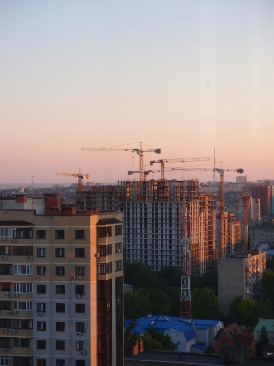 a very tall building with a lot of cranes on top