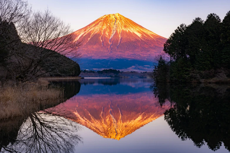 a large mountain rising above a body of water