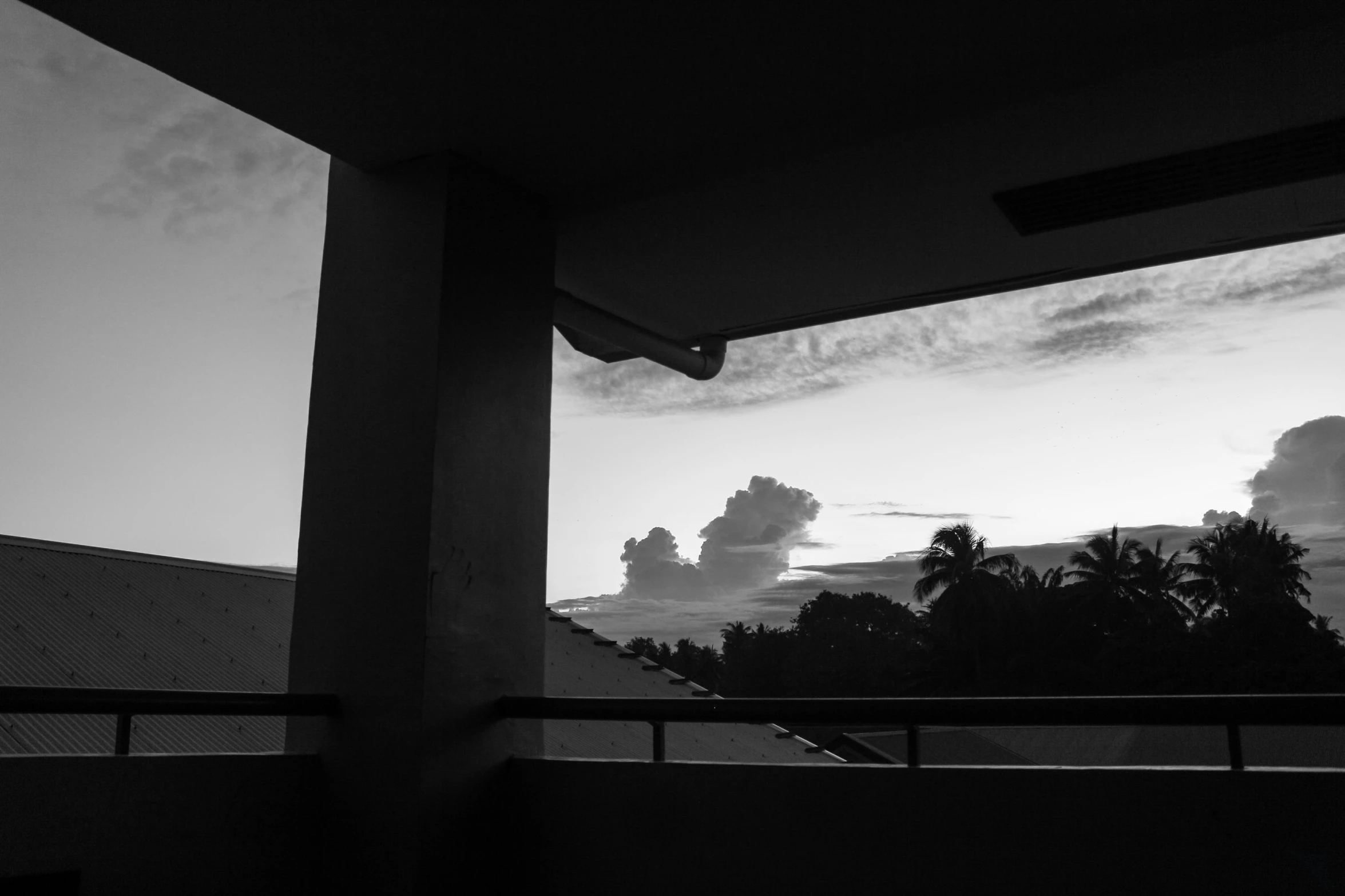 silhouette view of clouds in the sky outside an open window