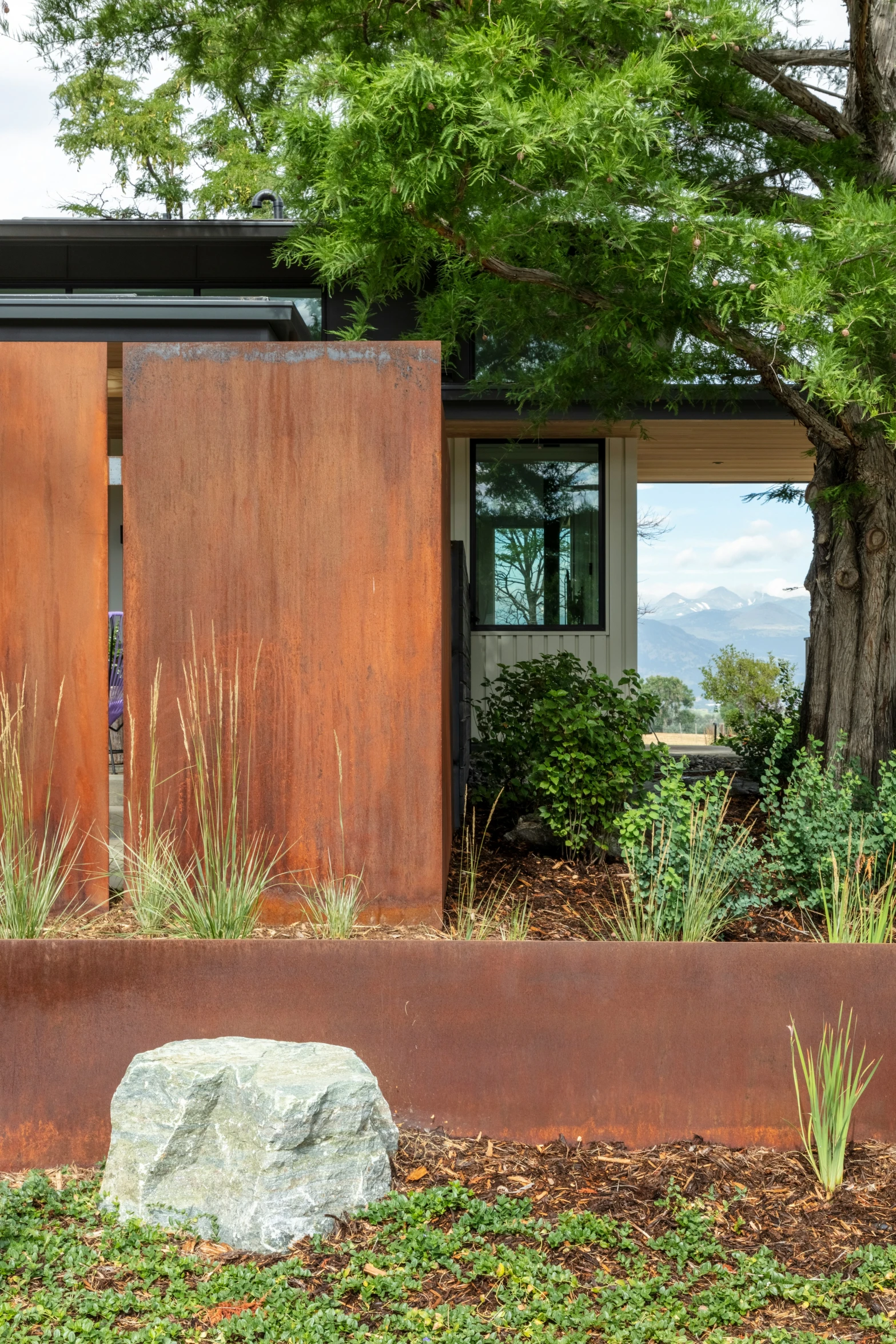 a brown fence surrounding a tree and building