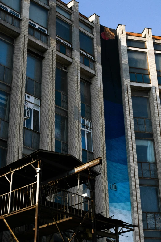 a large blue mural of a building and some people on a skateboard