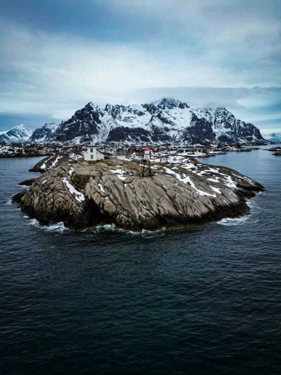 a white snow covered island near the water