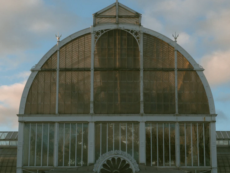 a large greenhouse building with many glass walls