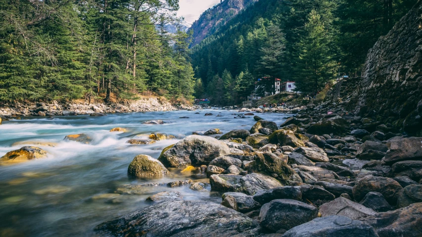 water flowing down a river surrounded by lots of rocks