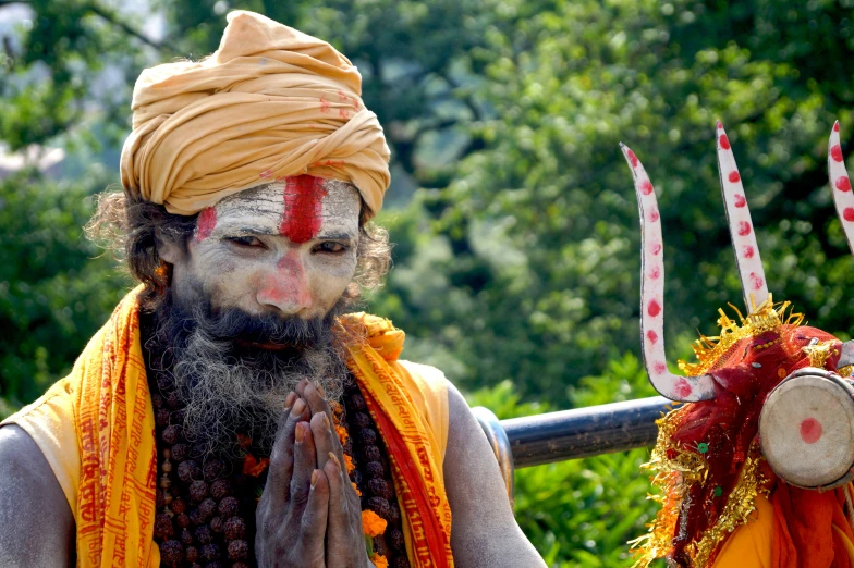 two men dressed in various indian outfits, standing next to each other