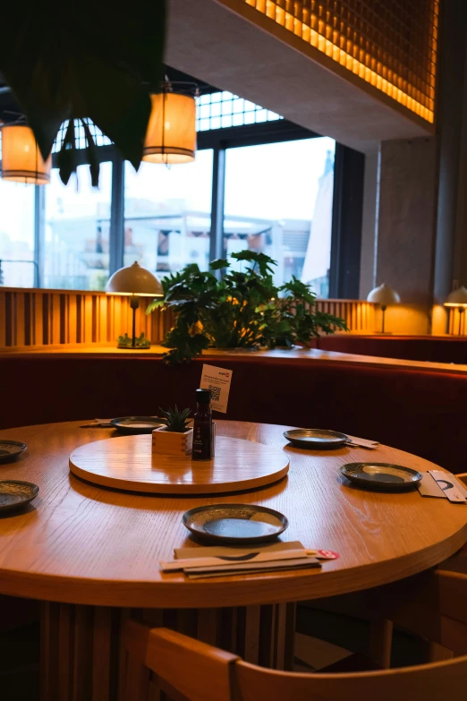 a table and some chairs with place setting on it