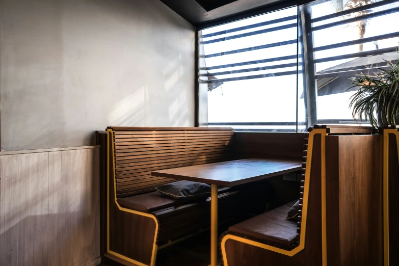 a booth with a wooden table and chair