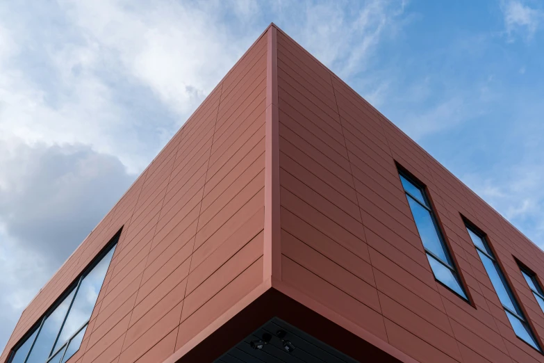 a view of a very tall brick building with three windows