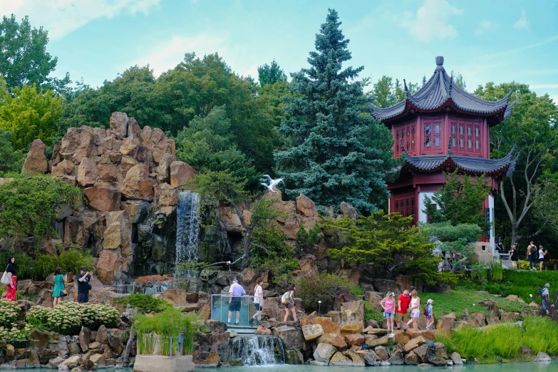 people are standing near the water fountain