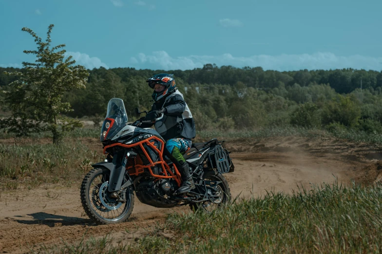 a person is riding on an orange motorcycle