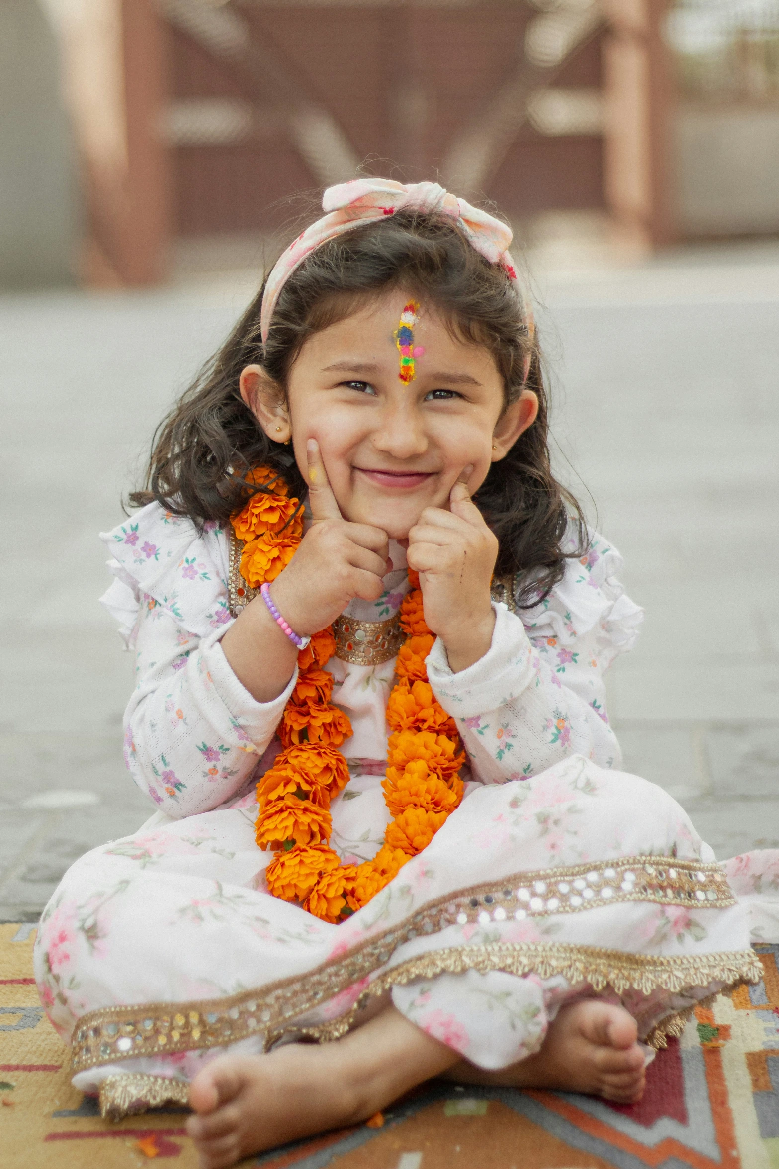 girl smiling while sitting down on the ground